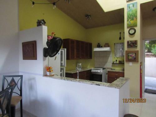 a kitchen with a refrigerator and a counter top at Mountain House with Pool in Altos del Maria in Sorá