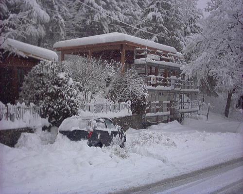 a yard covered in snow in front of a building at Hotel Bruna in Lizzano in Belvedere