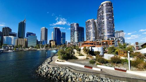 a view of a city with a river and buildings at 303 Cheerful City Central Crib Sleeps 2 in Perth