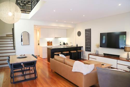 a living room with a couch and a table at Seabreezes South Fremantle in South Fremantle