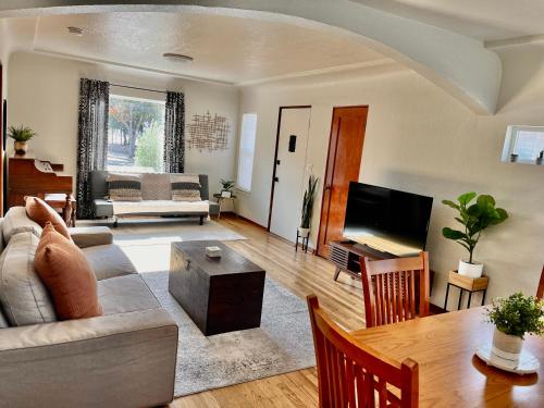 a living room with a couch and a table at Charming 2BD downtown home by bike trail, river and coffee! in Redding