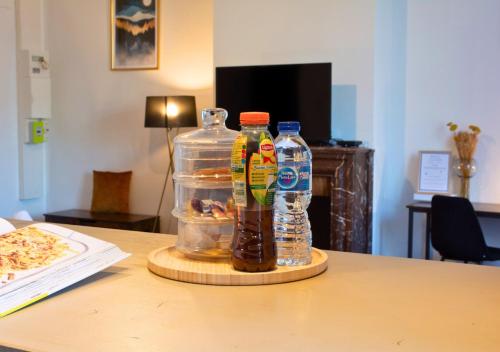 two bottles of drinks sitting on top of a table at Le Charme D'Antan - Terrasse - Balcon - Hypercentre Evreux in Évreux