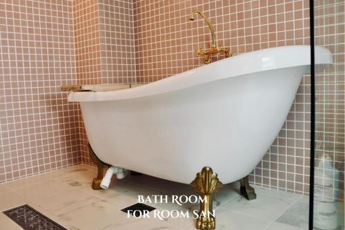 a bath room with a white tub in a bathroom at THE ROOT2 HOTEL in Kyoto