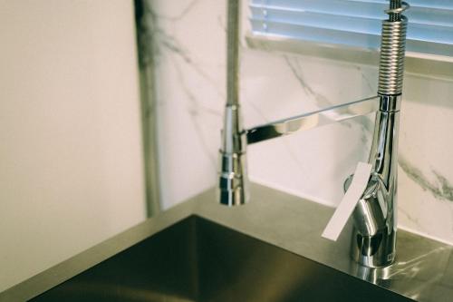a sink with a faucet on top of it at THE ROOT2 HOTEL in Kyoto