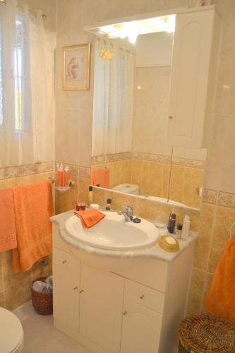 a bathroom with a white sink and a mirror at Los Horizontes No70 in Benalmádena