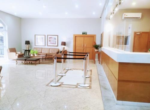a large living room with a counter and a living room at Apto com linda vista - Hotel em frente Allianz Parque com estacionamento in Sao Paulo