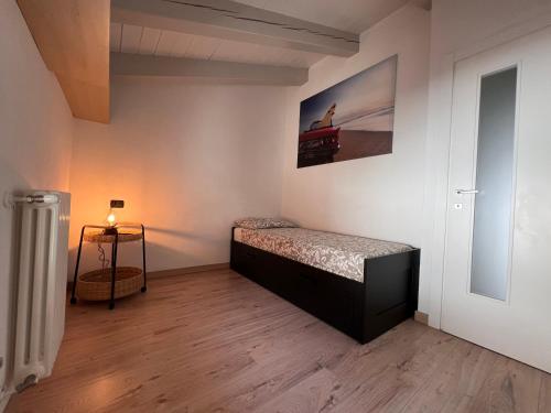a bedroom with a bed and a picture on the wall at Grazioso appartamento 2 in Aosta