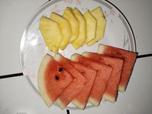a plate with slices of watermelon and fruit on it at Osa House - Drake Corcovado Tours in Drake