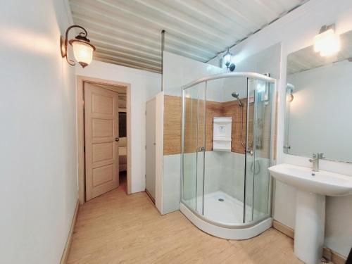 a bathroom with a glass shower and a sink at Happy Land Residence in Ban Nam Cham