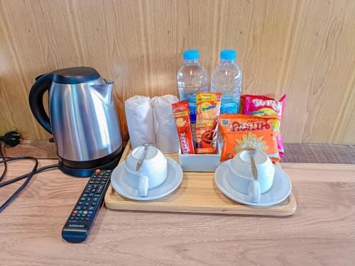 a counter with a coffee maker and a blender and snacks at Tayama Farm Khaoyai in Nakhon Ratchasima