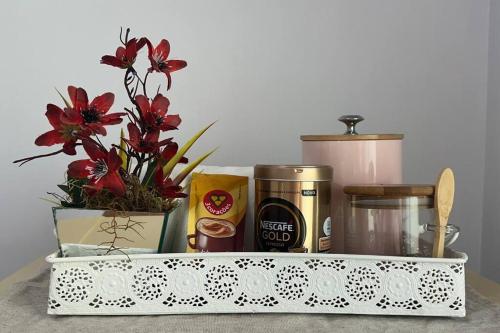a container with flowers and other items on a counter at Apto 104 Flamingo, 1P, Único in Pato Branco