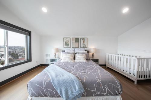 a bedroom with a bed and a large window at Queen Anne Modern Family Home Free Parking - SLU - Gym in Seattle