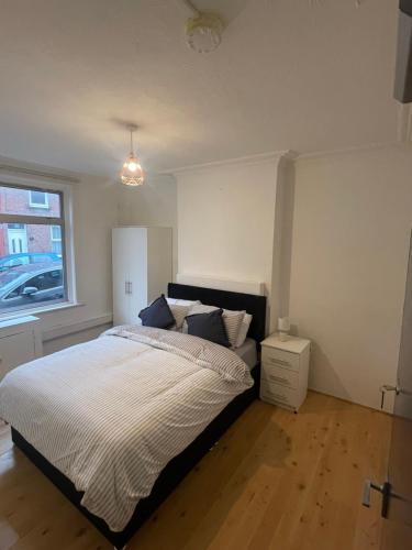 a bedroom with a bed and a window at Close to Central in Luton