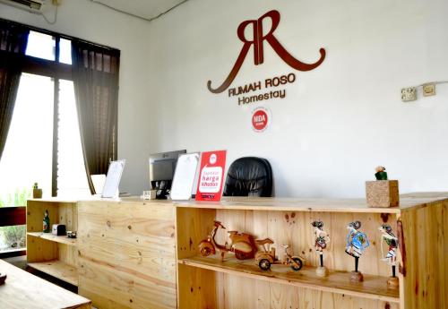 a room with a wooden counter with a sign on the wall at Rumah Roso Homestay in Yogyakarta