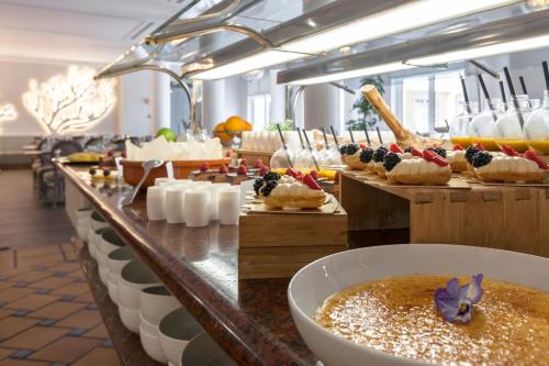 a buffet line with cakes and desserts on display at Praia D'El Rey Marriott Golf & Beach Resort in Casal da Lagoa Seca