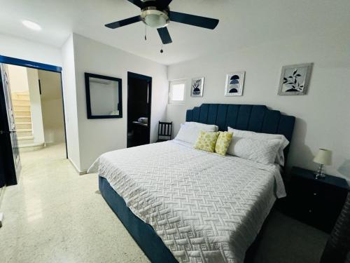 a bedroom with a bed and a ceiling fan at Mango y Jobo - Relaxed Mountain & Sea Panoramic view - 10mins drive to beach and city in San Felipe de Puerto Plata