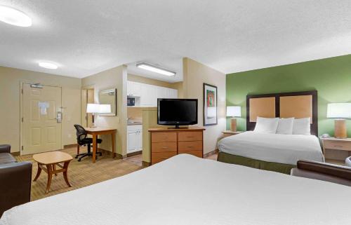 a hotel room with two beds and a flat screen tv at Extended Stay America Suites - Corpus Christi - Staples in Corpus Christi
