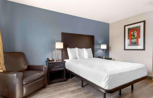 a hotel room with a bed and a chair at Extended Stay America Suites - Fort Worth - City View in Fort Worth
