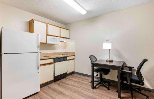 a small kitchen with a desk and a refrigerator at Extended Stay America Suites - Cincinnati - Blue Ash - Reed Hartman in Blue Ash