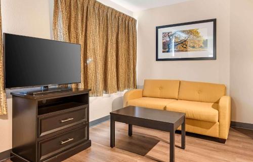 a living room with a couch and a flat screen tv at Extended Stay America Suites - Cincinnati - Blue Ash - Reed Hartman in Blue Ash