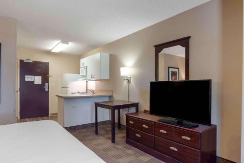 a hotel room with a bed and a flat screen tv at Extended Stay America Suites - Orange County - Lake Forest in Foothill Ranch