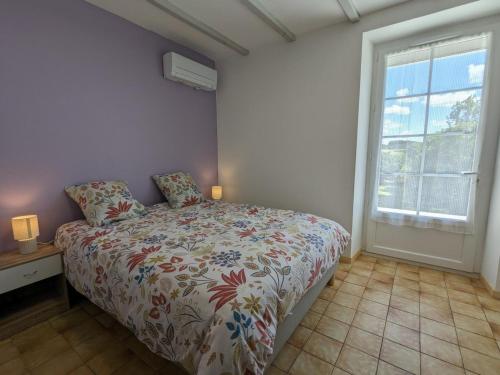 a bedroom with a bed and a window at Maison spacieuse avec piscine privée, climatisation, Wi-Fi, animaux acceptés et parking - FR-1-653-268 in Montbron
