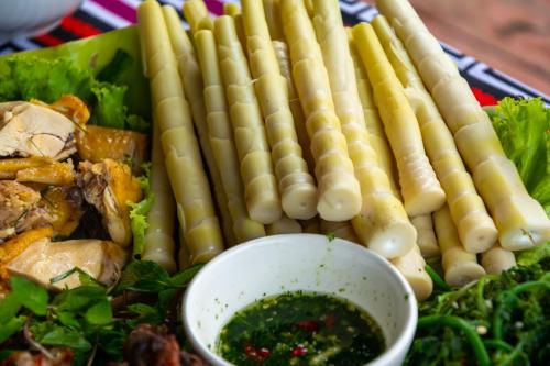a plate of food with sausages and a salad at Truong Nhan Tram Tau Homestay in Cham Ta Lao