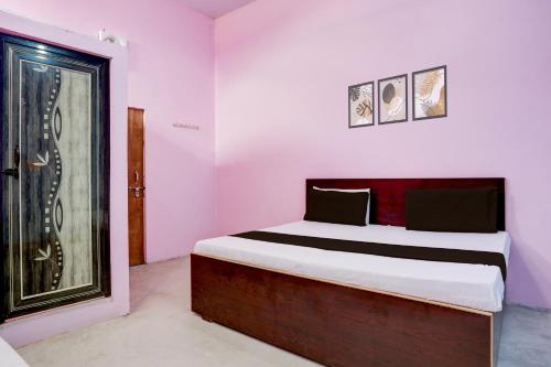 a bedroom with a bed and a glass door at Hotel O BLUE DIAMOND HOTEL in Alīgarh
