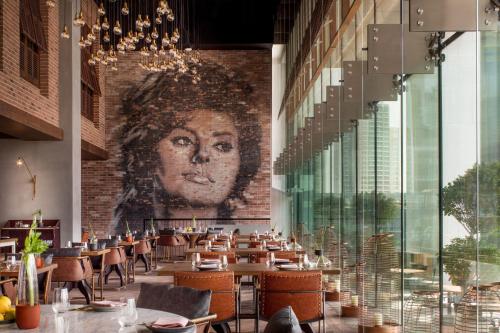 a restaurant with a mural of a woman on the wall at The St. Regis Downtown Dubai in Dubai