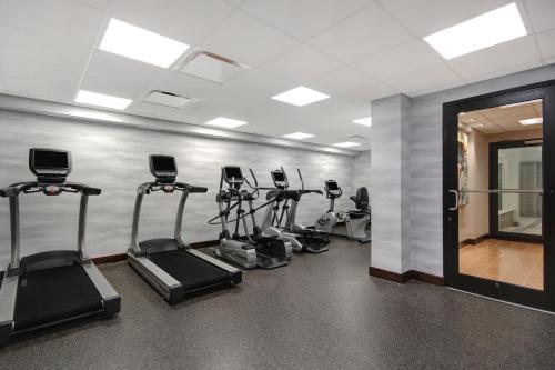a gym with several tread machines in a room at Fairfield Inn and Suites by Marriott Rochester West/Greece in Rochester