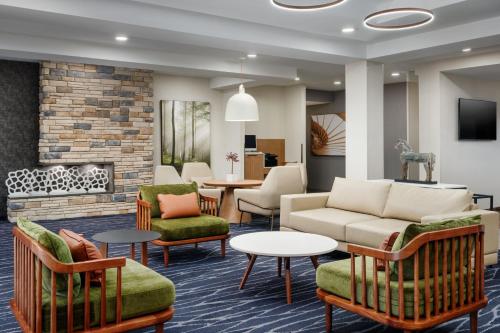 a lobby with a couch and chairs and a fireplace at Fairfield Inn and Suites by Marriott Birmingham / Bessemer in Bessemer