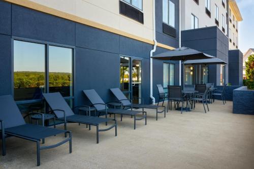 a group of chairs and tables outside of a building at Fairfield Inn and Suites by Marriott Birmingham / Bessemer in Bessemer