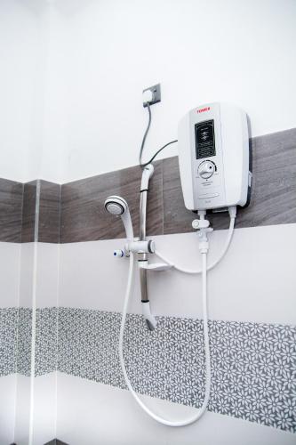 a shower in a bathroom with a white machine at River Relax Villa in Ahangama