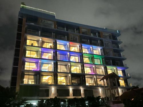 a building with colorful lights on it at night at The Blue Mavi Hotel in Chalong 