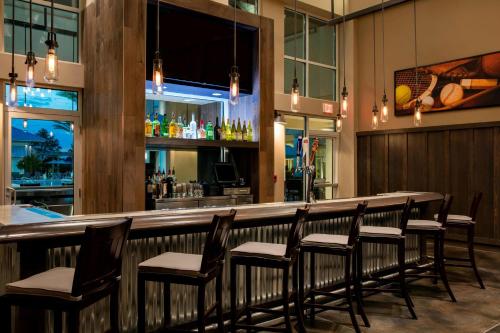 a bar in a restaurant with a bunch of chairs at SpringHill Suites by Marriott Orlando at FLAMINGO CROSSINGS Town Center-Western Entrance in Orlando