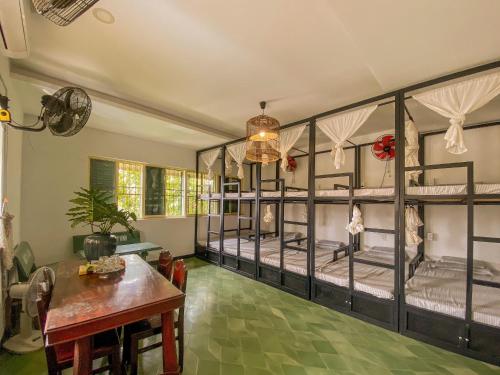 a room with four bunk beds and a table at Homestay in Tay Ninh in Tây Ninh