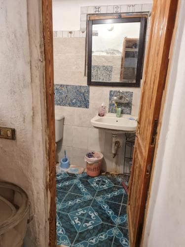 a bathroom with a sink and a mirror at Andyvone at yvone in Dahab