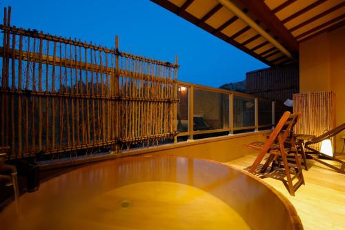 a balcony with a glass table and a fence at Yumenoian Yuyake Koyake in Himeji