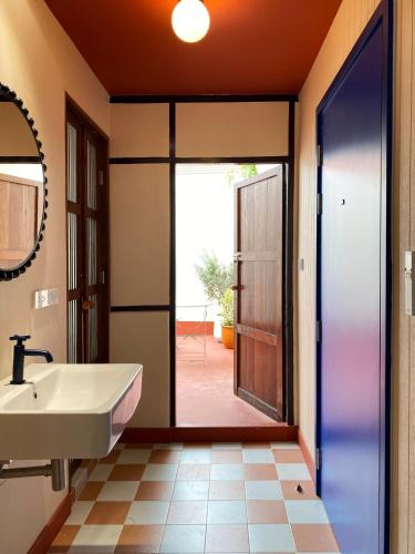 a bathroom with a sink and a mirror at Blu Dock Restel Bangkok in Bangkok