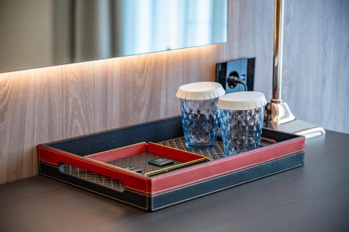 a tray with two glasses sitting on a table at Sky Airport Hotel in Cluj-Napoca