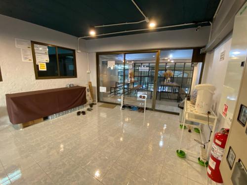 an empty room with a large window and a table at Sleep At Home - Don Mueang in Bangkok