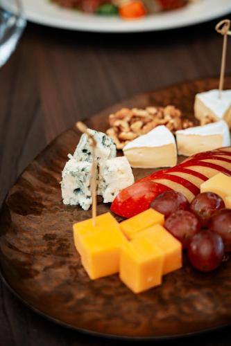 a plate of cheese and other foods on a table at Sky Airport Hotel in Cluj-Napoca