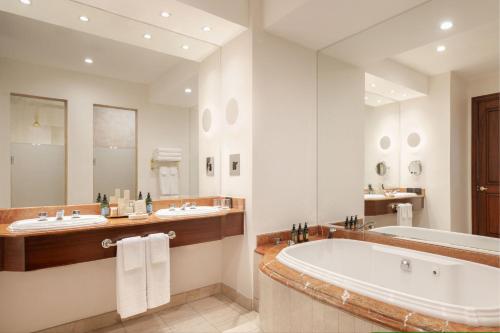 a bathroom with two sinks and a bath tub at JW Marriott Quito in Quito