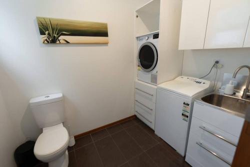 a small bathroom with a toilet and a sink at Hilltop Escape - Spa & Views in Greymouth