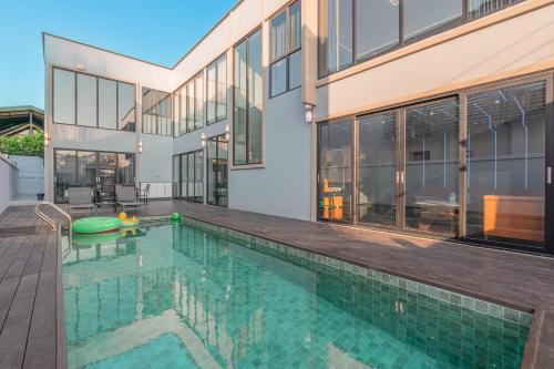 a swimming pool in front of a house at T M L-Jomtien Beach 4 bedrooms - independent swimming pool and KTV in Jomtien Beach