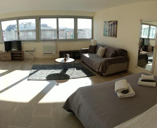 a living room with a bed and a couch at Athens Experience 1 in Athens