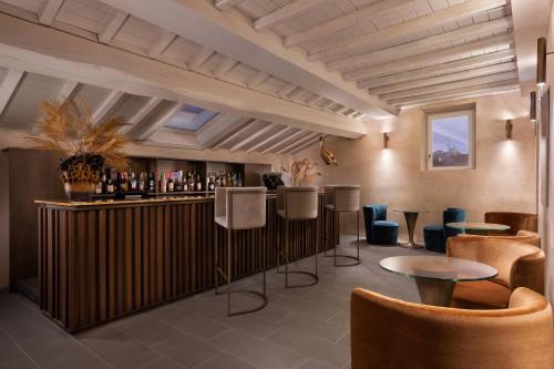 a bar in a restaurant with chairs and tables at Grand Universe Lucca, Autograph Collection in Lucca