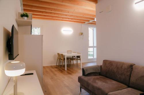 a living room with a couch and a table at Barchessa Cappelletto in Torre di Mosto