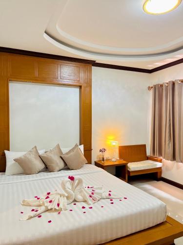a bedroom with a large bed with flowers on it at Lanta Nature House in Ko Lanta