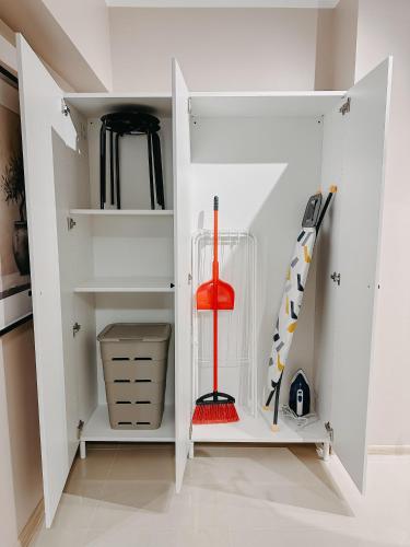 a walk in closet with white cabinets and skis at AGOLL Centru - self checkin in Reşiţa